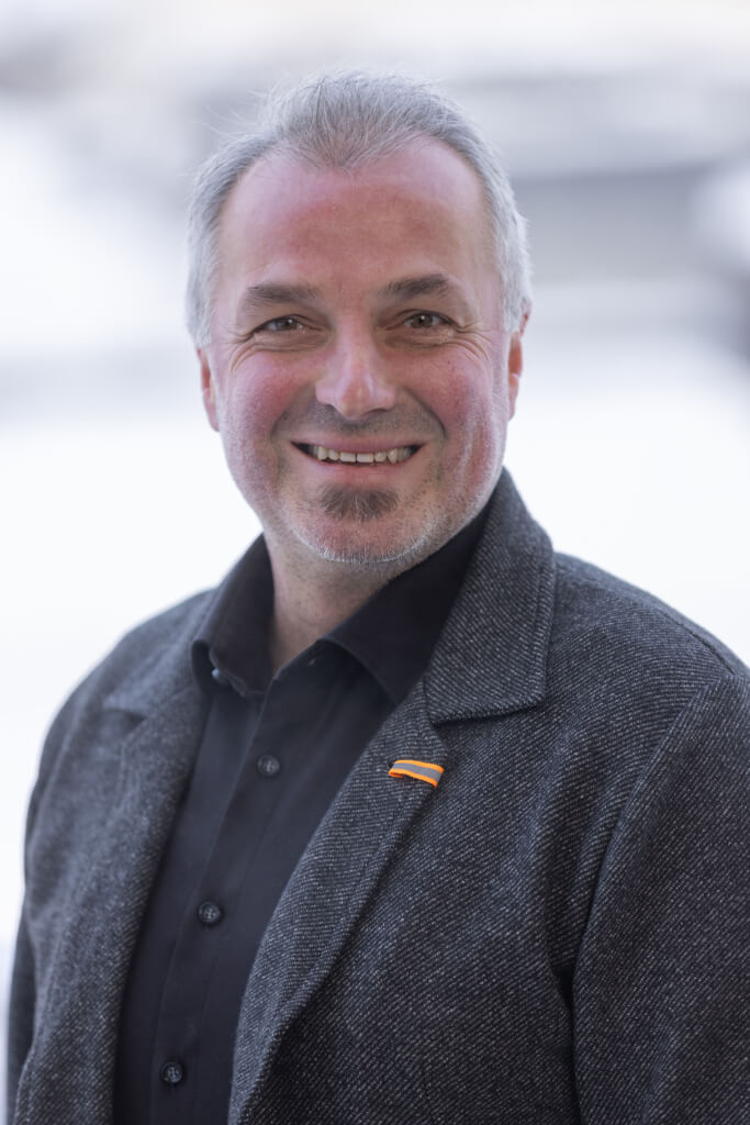 Lächelnder Mann in grauem Sakko, engagiert für die SPÖ Kaprun und die Gemeinschaft.